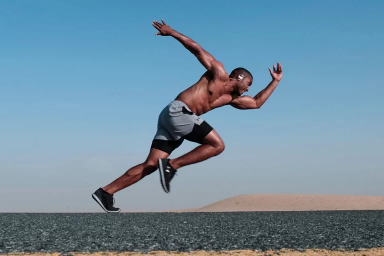 Black man running on road.