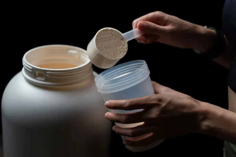 closeup of person putting powder in container