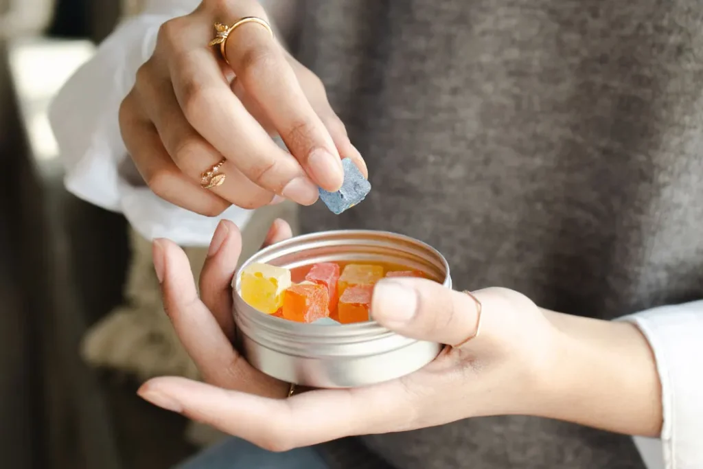 Women eating Keoni cbd gummies