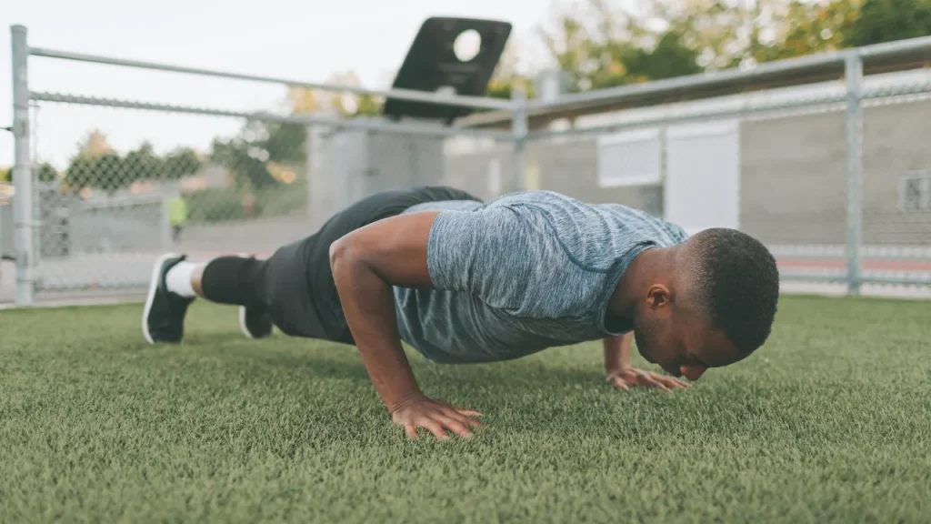 Man is doing exercise in a park. 