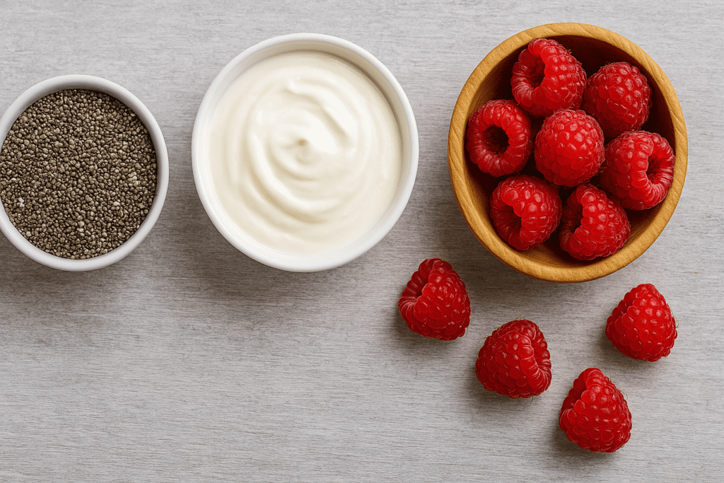 Best Foods to Eat to Burn Belly Fat: How Smart Nutrition Choices Can Support a Healthier Lifestyle 1 Flat lay of chia seeds, plain yogurt, and fresh raspberries in bowls, visually highlighting foods that support belly fat loss.