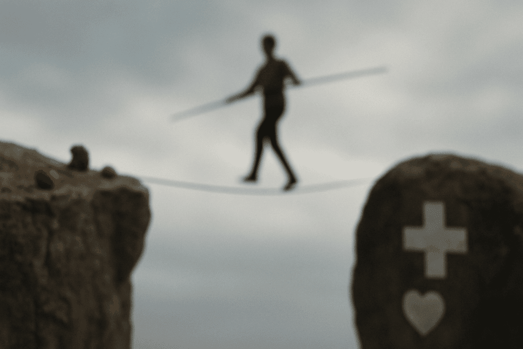Blurry tightrope walker crossing between cliffs symbolizing caloric restriction and malnutrition, illustrating the question: Can Not Eating Make You Lose Weight