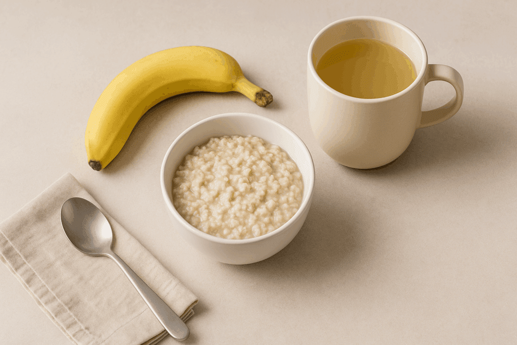 The Essential Guide to Foods That Help with Nausea: What to Eat (and Avoid) for Gentle Gut Relief and Recovery 3 Small bowl of plain oatmeal, banana, and mild broth in a ceramic mug—comforting foods that help with nausea.