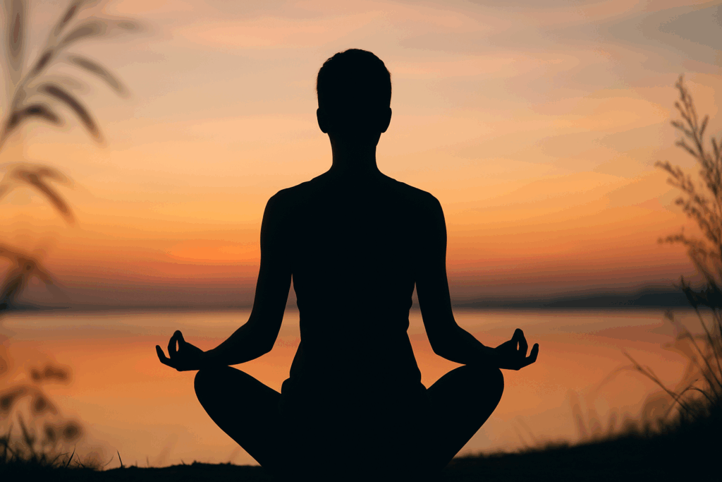 Person meditating by a calm lake at sunrise, illustrating how to strengthen a weak heart through mindfulness and stress reduction.
